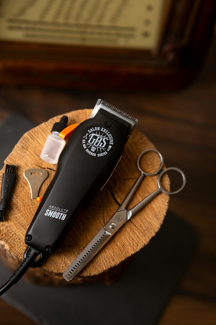 A clipper and a pair of thinning shears resting on a round of oak